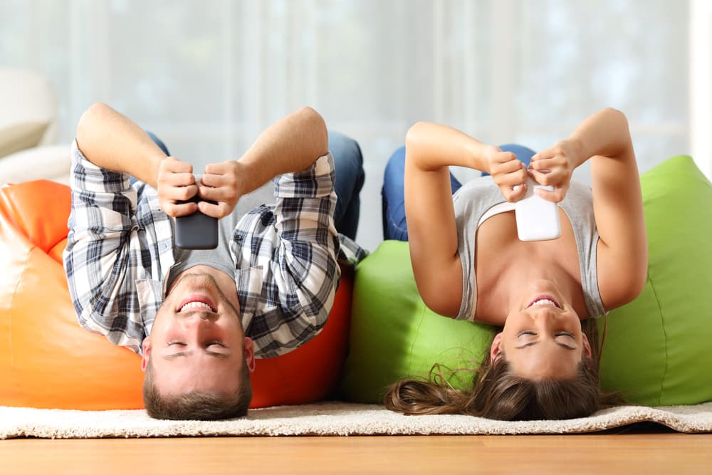 Upside-down on a couch using phones